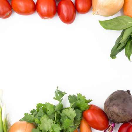 Fresh vegetables on a white background, closeup: Beet, green onions, coriander, tomato, onions,...