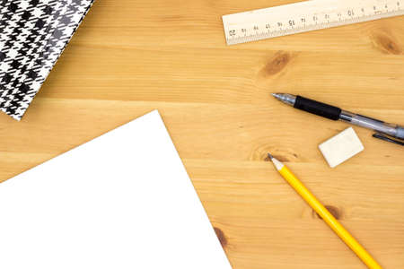 The workplace of the student, the home workplace. Closed notebook, pencil, glasses, ballpoint pen, eraser, ruler. Flat lay. Stationery.の写真素材