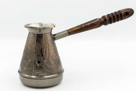 Copper Turk or Cezve with a wooden handle for brewing coffee isolated on a white background.の写真素材