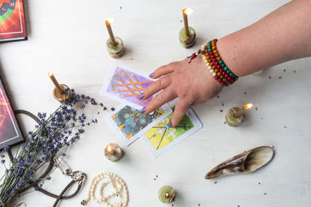 Russia, Moscow, June 11, 2021. Tarot cards on a wooden table. Magical rituals. Illustrative editorial.のeditorial素材