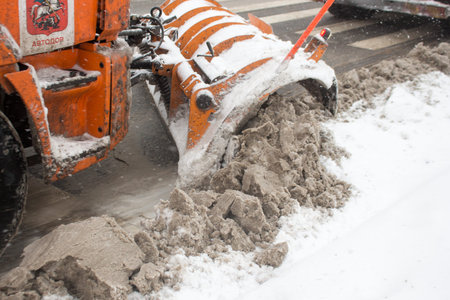 Snow removal equipment on the streets of the city. Road cleaning after heavy snowfall.