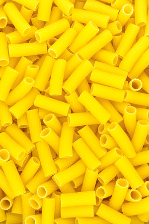 Uncooked short pasta tubes, elicoidali. Top view.