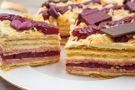 Pieces of cake. Puff pastry, cream and raspberry jam cake slices