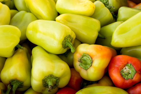 sweet yellow green peppers. Pile of colorful healthy vegetables background. Group of peppers...