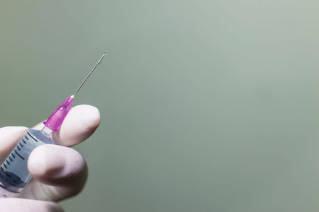 Close up Syringe in doctor's hands at clinic.