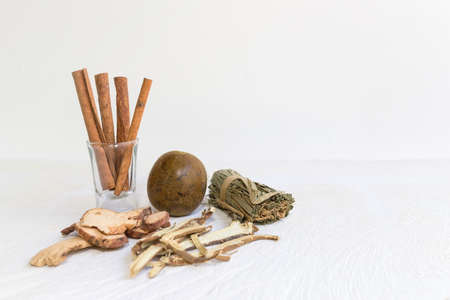 Dried bael, Cinnamon and Dried herbs or spices on a white wooden table, image with copy space for text or image.の写真素材