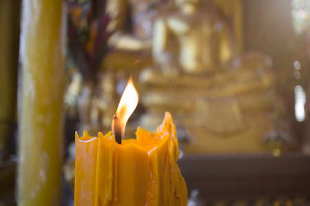 Candlelight with buddha statue in the Thai temple in Lampang province, Thailand.の写真素材