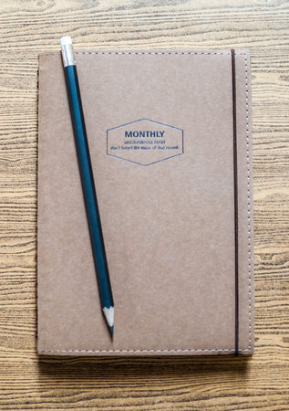recycled paper notebook front cover on wooden backgroundの写真素材
