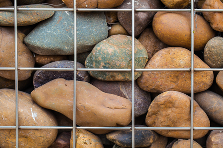 Stone wall in metallic netの写真素材