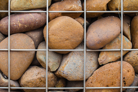 Stone wall in metallic netの写真素材