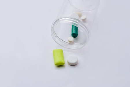 Medicine pills tablets and capsules on white plate for patient.