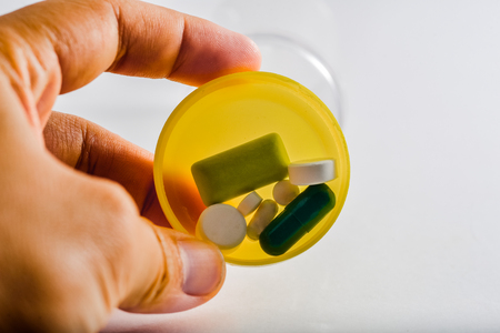 Medicine pills tablets and capsules on white plate for patient.の写真素材