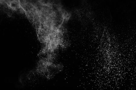 White powder explosion on black background.の写真素材
