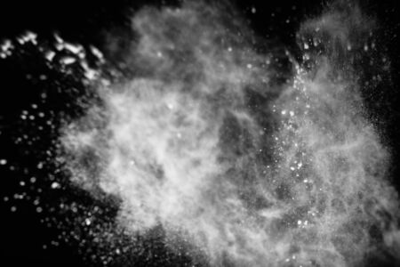 White powder explosion on black background.の写真素材