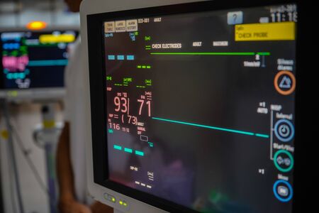 Modern vital sign monitor on patient background at ward in the hospital.の写真素材