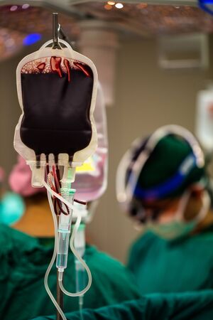 Blood in a bag had be gave to help patient that was operating by surgeon and his medical team.の写真素材