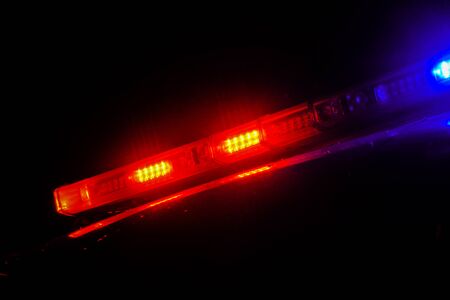 Strobelight bar on top of police car flashing red and blue.の写真素材