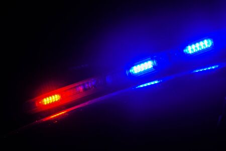 Strobelight bar on top of police car flashing red and blue.の写真素材