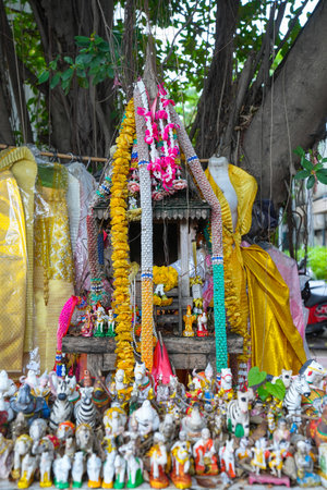A spirit house or Joss house built for guardian spirit to reside with Traditional thai costumes and Red soft drink is the belief of the Thai villagers. Selective focus.の写真素材