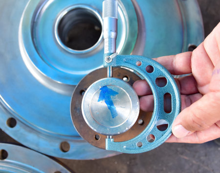 Technician use an Out-side Micrometer to measure the shaft's diameter. In the Water Circulation Pump repair workの写真素材