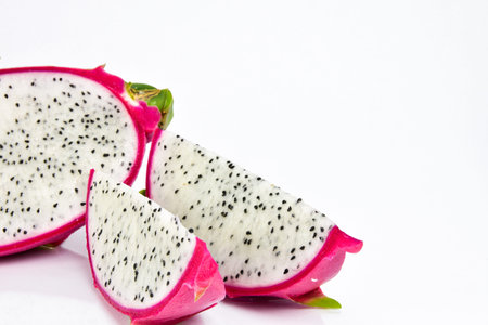 Close up the sliced dragon fruit on white background. Dragon fruit is popular as a fresh fruit.Is a mixture of fruit salad or blended into juice.の写真素材