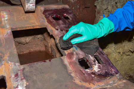 Workers use cleaner for remove the penetrant from the welding of structure.This is second step of Penetrant Testing (PT). の写真素材