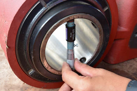 Technician use a Inside Micrometer to measure the diameter inside of the inner ring of bearing.の写真素材