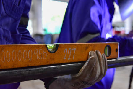 Worker check the level of the pipe in the horizontally with a Water level Meter Indicator.の写真素材