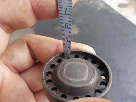 Technician measuring the hole size of a spay nozzle with a Taper gauge.の写真素材