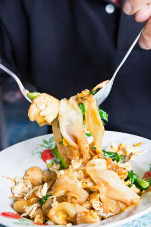 eating stir fried noodleの写真素材