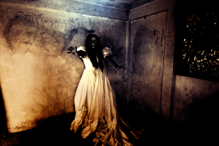Night of the Revenge,Ghost in Haunted House,Mysterious Woman in White Dress Standing in Abandon Building,Horror Background For Halloween Concept and Book Cover Ideasの写真素材