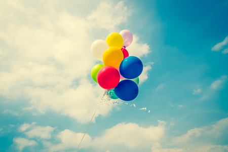 Vintage colorful balloons on blue skyの写真素材