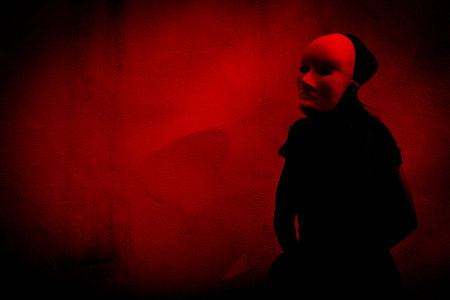 Mysterious woman in black dress wearing white mask,Scary background for book coverの写真素材