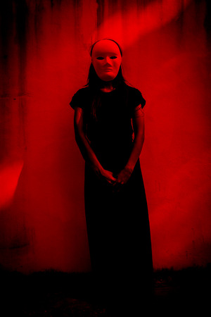 Mysterious woman in black dress wearing white mask,Scary background for book coverの写真素材