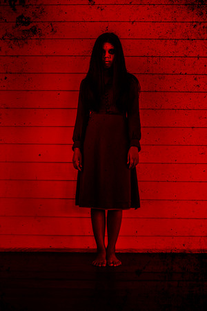 Girl standing in front of the wall,Scary background for halloween concept and book cover ideasの写真素材