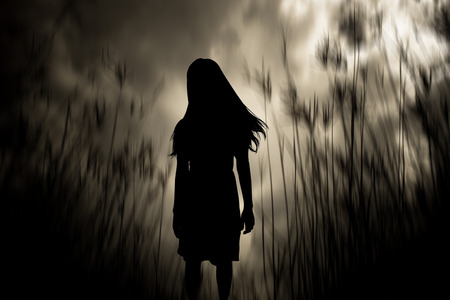 Girl walking in the woods,Horror Background For Halloween Concept And Movie Poster Projectの写真素材