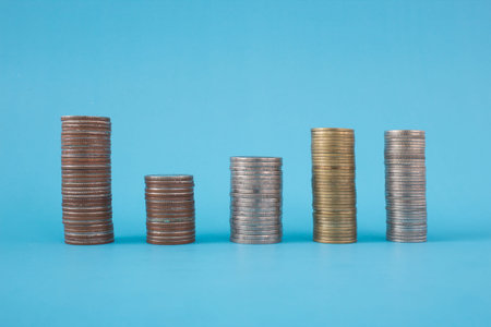 Stack of coins on blue soft background