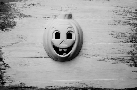 Pumpkin mask on wooden floor background for halloweenの写真素材