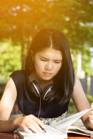 Asian teen student reading book preparing for examの写真素材