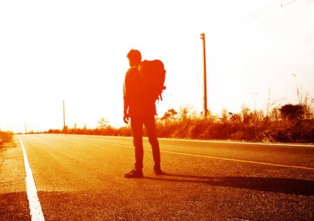 Traveler with backpack on the roadの写真素材