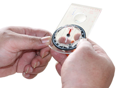 Man's hand holding a compass. Isolated on white