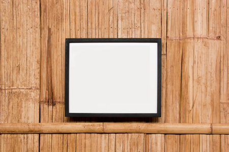 Wood plate on bamboo wicker wallの写真素材