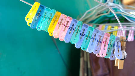 Colourful clothespin hanging on hangerの写真素材