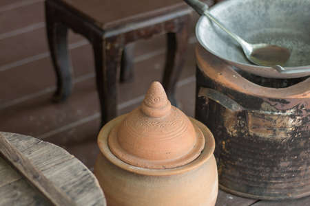 Thai clay pot lid placed in the kitchen near the charcoal stoveの写真素材
