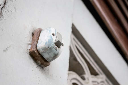 Old switch on the wooden base on the white wallの写真素材