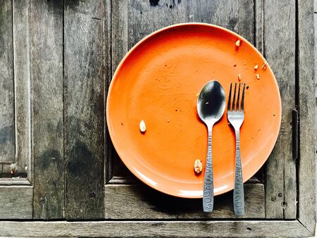 Plate on a wooden table after eating.の素材