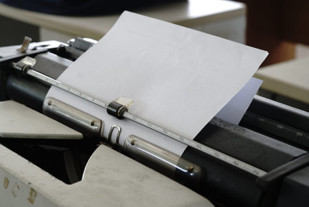 Close-up of a typewriter with a blank sheet of paper