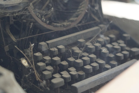 Close-up photo of an old typewriter with keys on a black backgroundの写真素材