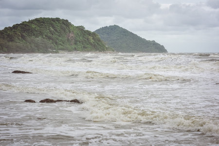 Stormy sea waves beating against beach rocks- beautiful seascape in Chathaburi, Thailand