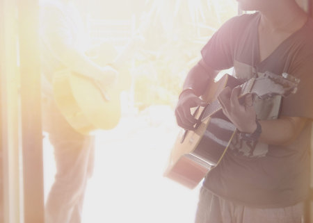 man play accustic guitar band